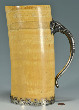 This late 19th century elephant tusk with Gorham sterling silver mounts, including an elephant head handle, measures over 10 inches tall and is estimated at $5,000-7,000. Case Antiques image.